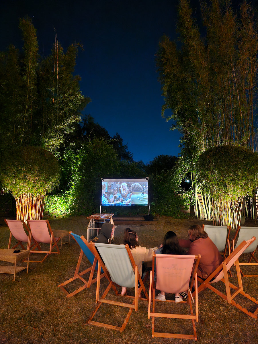 movie night with chairs and screen with trees